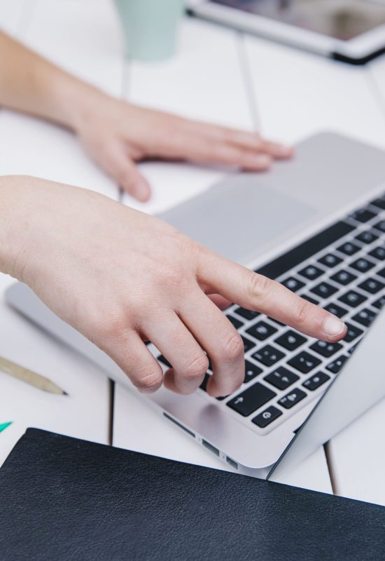 crop-woman-pointing-screen-laptop